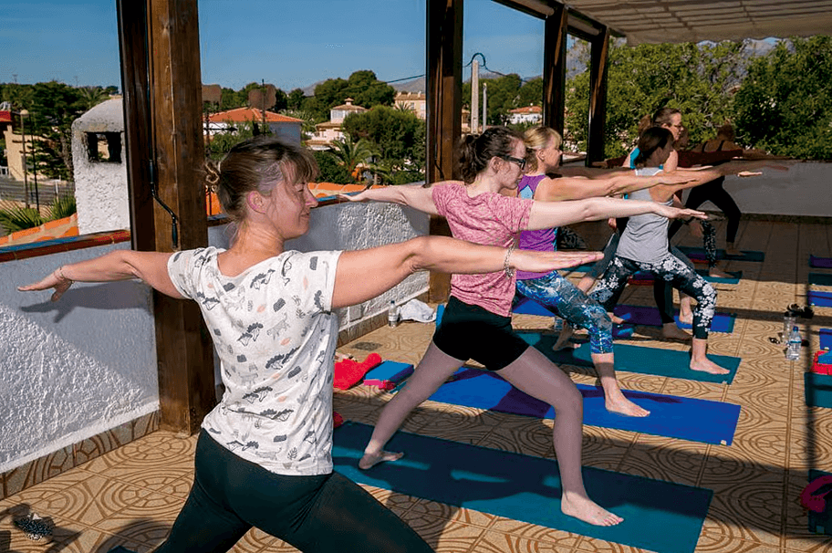 Daily yoga class supporting weight loss and detox during a retreat in Spain