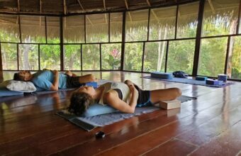 Yoga and meditation session in the open-air shala at Tambo Ilusión Amazon retreat center in Tarapoto, Peru