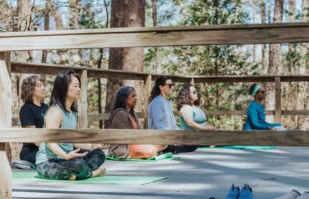 Women doing yoga outdoors at Retreat in the Pines, East Texas