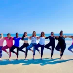 Women practicing yoga at Serenity House during a women's yoga wellness retreat in Tybee Island Georgia